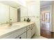 Bathroom with a large sink and cabinets with view to the bedroom and outdoor patio at 1380 Gulf Blvd # 307, Clearwater Beach, FL 33767