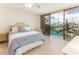 Bedroom with sliding glass door to a balcony with a beach view at 1380 Gulf Blvd # 307, Clearwater Beach, FL 33767
