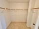 Walk-in closet with shelving, neutral paint, and tile floors at 1380 Gulf Blvd # 307, Clearwater Beach, FL 33767