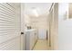 Laundry room featuring a washer, dryer, freezer, and shelving at 1380 Gulf Blvd # 307, Clearwater Beach, FL 33767