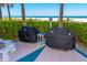 Outdoor patio featuring two barbecue grills with ocean view at 1380 Gulf Blvd # 307, Clearwater Beach, FL 33767