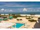 View of the outdoor pool and deck with lounge chairs and ocean view at 1380 Gulf Blvd # 307, Clearwater Beach, FL 33767