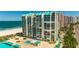 Aerial view of beachfront building with pool and ocean at 1380 Gulf Blvd # 307, Clearwater Beach, FL 33767