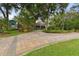 Stunning home with a long, curved brick driveway and lush, mature landscaping, creating great curb appeal at 3204 Polo Pl, Plant City, FL 33566