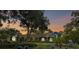Charming home with a beautiful sunset backdrop, lush landscaping, and manicured lawn at 3204 Polo Pl, Plant City, FL 33566