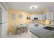 Bright eat-in kitchen features white cabinets, granite counters, and modern appliances at 6131 Bahia Del Mar Blvd # 236, St Petersburg, FL 33715