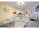 Bright eat-in kitchen features white cabinets, granite counters, and modern appliances at 6131 Bahia Del Mar Blvd # 236, St Petersburg, FL 33715