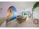 Charming dining area with a lovely mural and view to the golf course at 6131 Bahia Del Mar Blvd # 236, St Petersburg, FL 33715