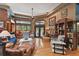Open living room with hardwood floors, ample seating, and a stone fireplace at 3204 Polo Pl, Plant City, FL 33566