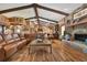 Spacious living area with hardwood floors, exposed beams, and a stone fireplace at 3204 Polo Pl, Plant City, FL 33566
