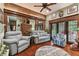 Spacious living room with hardwood floors, comfortable seating, and large windows at 3204 Polo Pl, Plant City, FL 33566