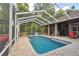 Inviting pool area with covered patio, lush landscaping, and comfortable seating at 3204 Polo Pl, Plant City, FL 33566
