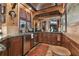Well-appointed wet bar featuring granite countertops and wood cabinetry at 3204 Polo Pl, Plant City, FL 33566