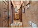 Long hallway with decorative walls and hardwood floors at 3204 Polo Pl, Plant City, FL 33566