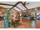 Grand living room showcasing high ceilings, hardwood floors, and exposed beams at 3204 Polo Pl, Plant City, FL 33566