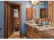 Bathroom with granite countertop vanity and wood cabinets at 3204 Polo Pl, Plant City, FL 33566