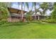 Landscaped backyard with covered patio and outdoor kitchen at 3204 Polo Pl, Plant City, FL 33566