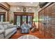 Bright living room featuring hardwood floors, comfy seating, and access to outdoor patio at 3204 Polo Pl, Plant City, FL 33566