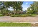 House exterior with circular driveway and manicured landscaping at 3204 Polo Pl, Plant City, FL 33566