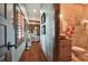 Hallway with hardwood floors and access to a bathroom at 3204 Polo Pl, Plant City, FL 33566
