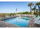 Community pool with plenty of lounge chairs for relaxation at 4510 Gulf Blvd # 508, St Pete Beach, FL 33706