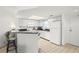 Efficient galley kitchen with white appliances and granite countertops at 4510 Gulf Blvd # 508, St Pete Beach, FL 33706