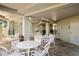 Covered patio with tables and chairs, great for outdoor dining at 4510 Gulf Blvd # 508, St Pete Beach, FL 33706