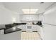 Bright kitchen featuring white cabinets, granite counters & appliances at 4510 Gulf Blvd # 508, St Pete Beach, FL 33706