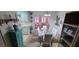 Dining area with glass table and chairs, view into living room and kitchen at 9901 111Th Ln, Seminole, FL 33772