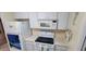 Kitchen features electric stovetop, microwave, and refrigerator at 9901 111Th Ln, Seminole, FL 33772