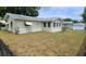 Large backyard with a mostly-bare lawn and wooden fence at 9901 111Th Ln, Seminole, FL 33772