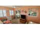 Bright sunroom with seating area, TV, and view of dining area at 9901 111Th Ln, Seminole, FL 33772