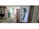 Hallway view with a large mirror and glimpse of the kitchen and living room at 9901 111Th Ln, Seminole, FL 33772