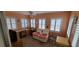 Relaxing sunroom with two armchairs, desk, and plenty of natural light at 9901 111Th Ln, Seminole, FL 33772