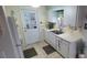 Efficient kitchen with double sink, microwave, and white cabinetry at 9901 111Th Ln, Seminole, FL 33772