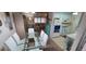 Bright dining area with glass table, white chairs, and kitchen view at 9901 111Th Ln, Seminole, FL 33772