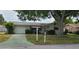 House exterior featuring a single-story home with a garage and landscaping at 9901 111Th Ln, Seminole, FL 33772