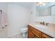 This bathroom features a single sink vanity with a wood cabinet and a standard toilet at 2228 Swedish Dr # 42, Clearwater, FL 33763