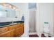 Well-maintained bathroom featuring a vanity with granite countertop and a glass-enclosed shower at 2228 Swedish Dr # 42, Clearwater, FL 33763