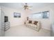 Bright bedroom features a ceiling fan, large window, and a comfortable sitting area at 2228 Swedish Dr # 42, Clearwater, FL 33763