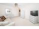 Spacious bedroom features a full dresser and armoire with a wall mounted television at 2228 Swedish Dr # 42, Clearwater, FL 33763