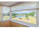 Bright room featuring large windows offering scenic views of the community lake at 2228 Swedish Dr # 42, Clearwater, FL 33763