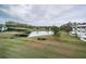 Scenic view of a community pond, surrounded by lush landscaping and residential buildings at 2228 Swedish Dr # 42, Clearwater, FL 33763