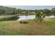 Scenic view of the community pond with lush greenery and landscaping at 2228 Swedish Dr # 42, Clearwater, FL 33763