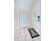 Bright entryway with tiled floor, coat closet, and door at 2228 Swedish Dr # 42, Clearwater, FL 33763