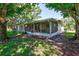 Outdoor screened porch with patio furniture, perfect for relaxing at 2875 Lomond Dr, Palm Harbor, FL 34684