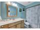 Bathroom with light blue walls, wooden vanity, and shower/tub combo at 2875 Lomond Dr, Palm Harbor, FL 34684