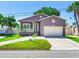 Charming one-story home with attached garage and manicured lawn at 3425 Overlook Ne Dr, St Petersburg, FL 33703