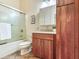Bathroom with wood vanity, shower/tub combo, and tiled floors at 3425 Overlook Ne Dr, St Petersburg, FL 33703