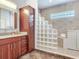 Bathroom features walk-in shower with glass block wall and modern vanity at 3425 Overlook Ne Dr, St Petersburg, FL 33703